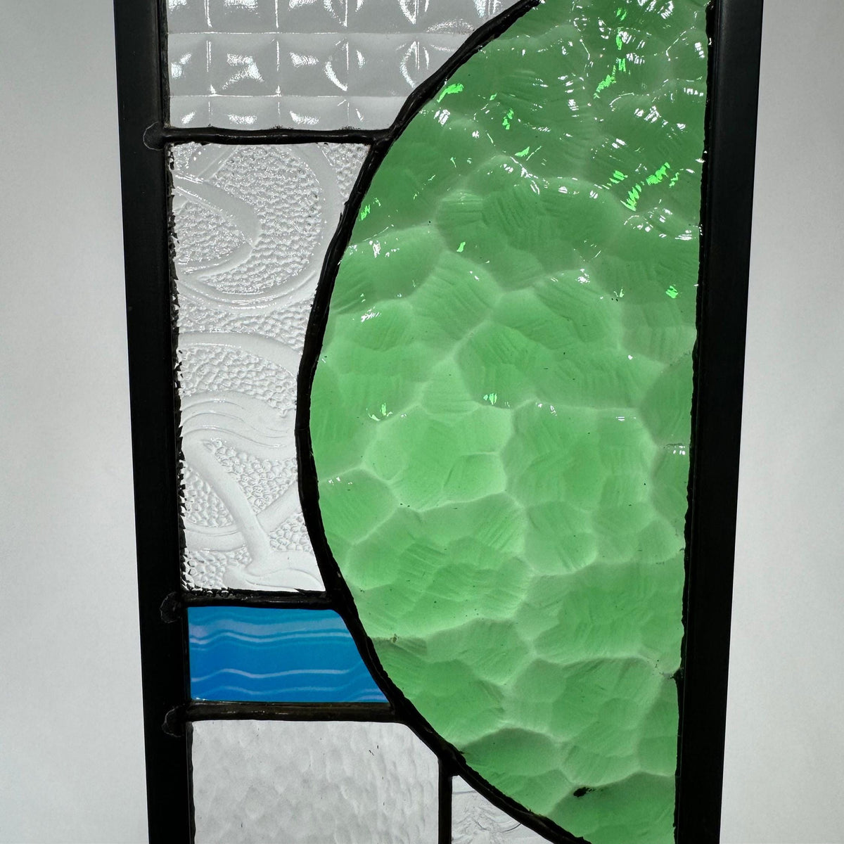 5" x 24" green half circle abstract stained glass panel